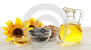 Composition with sunflower oil on wooden table against white background