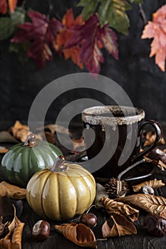 Composition with tea cup and ceramic pumpkins