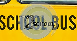 Composition of text back 2 school in black on yellow school bus