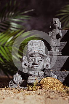 Statues of gods and the pyramid of the Aztec civilization are handmade