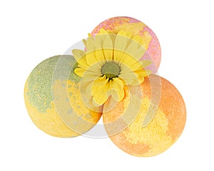 Composition of three bath bombs and yellow flower
