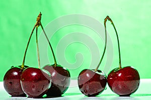Composition of three and two ripe sweet cherries