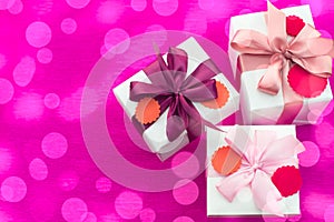 Composition three white boxes with a Satin ribbon Bow Background Saturation pink.