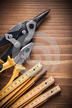 Composition of tin snips pliers wooden meter construction concep