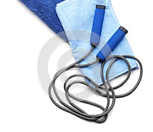 Composition with towels and jumping rope on white background, top view. Gym workout