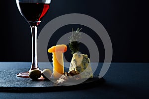 Composition of traditional appetizer for red wine on slate board