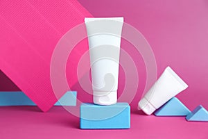 Composition with tubes of hand creams on pink background. Mockup for design