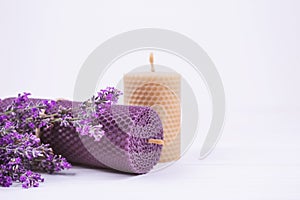 Composition with two handmade beeswax candles made with natural wax from fresh honeycomb and lavender essential oil