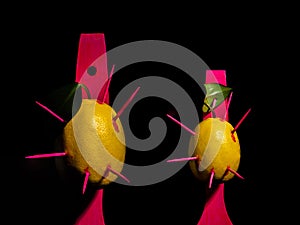 Composition with two lemons and arrows on a black background