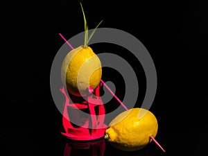 Composition with two lemons on a black background