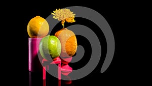 Composition with two lemons and lime on a black background