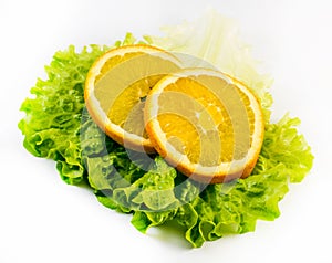 Composition of two slices of orange with salad on a white background