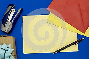 Composition Using Colorful Envelopes, Pencil, Blank Paper For Text, Gift Box, and Stapler