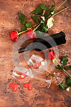Composition for Valentine`s Day. Roses, gift, glasses and wine, red hearts. Top view.