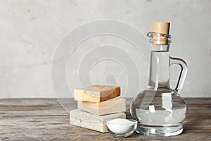 Composition with vinegar, baking soda and soap bars for cleaning on table.