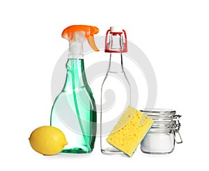 Composition with vinegar, lemon and baking soda on white background.