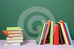 Composition with vintage old hardback books, colored background