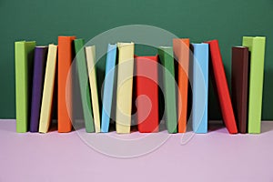 Composition with vintage old hardback books, colored background
