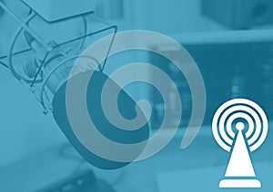 Composition of white broadcasting symbol and microphone in radio studio on blue background