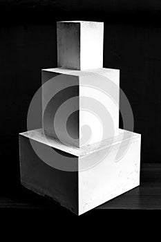 Composition of white cubes on black background