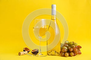 Composition wine and fruits on yellow background