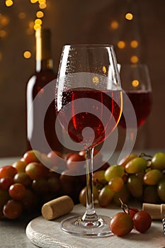 Composition wine and grape on brown background with blurred lights