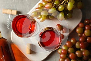 Composition wine and grape on gray background, top view