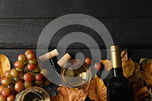 Composition wine and grape on wooden background, top view