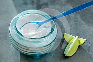 Composition withspoon of sodium bicarbonate vinegar and cleaning supplies on table. Space for text