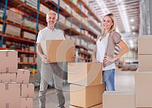 Composition of woman and man holding cardboard box with warehouse in background