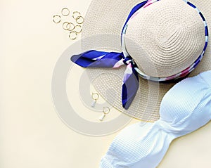 Composition of woman swimsuit,hat and fachion accesories on biege background,flat lay,top view. Travel concept