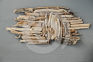 Composition from wooden twigs on a grey background