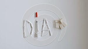 Composition with the word DIA from insulin syringes, lancets and sugar cubes.