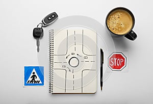 Composition with workbook for driving lessons on background, top view. Passing license exam