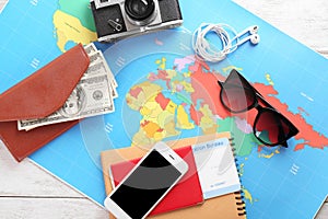 Composition with world map, money and passport on table. Travel concept