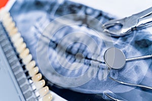 Composition of xray photo and dentist equipment and row of teeth. Close up.