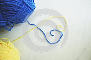 Composition with yarn balls on light blue background