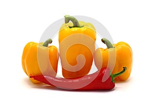 Composition of yellow and red sweet peppers of different sizes on a light background.