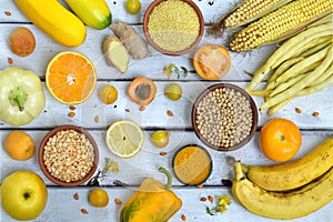 Composition of yellow vegetables, beans and fruits - banana, corn, lemon, plum, apricot, pepper, zucchini, tomato, asparagus bean,