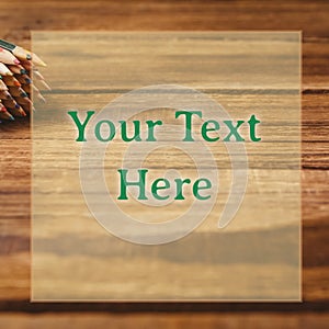 Composition of your text here over coloured pencils on wooden background