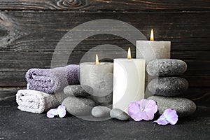 Composition with zen stones, towels and candles on table