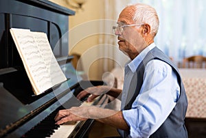 Compositor creating new music with piano at home photo