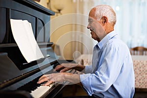 Compositor creating new music with piano at home photo