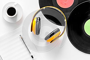 Compositor`s workplace. Vinyl records, headphones, music notes on white background top view photo