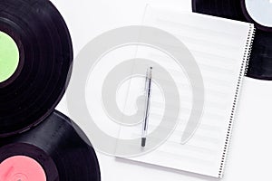 Compositor`s workplace. Vinyl records and music notes on white background top view