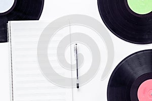 Compositor`s workplace. Vinyl records and music notes on white background top view photo
