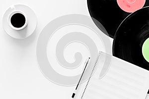 Compositor`s workplace. Vinyl records and music notes on white background top view copyspace