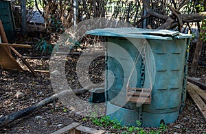 A compost bin in a cooperative and community ecological garden