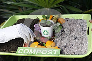 Compost and composted soil cycle as a composting pile of rotting kitchen scraps with fruits and vegetable garbage waste turning