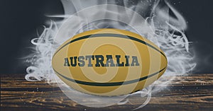 Compostion of rugby ball with text australia on black background with white blur